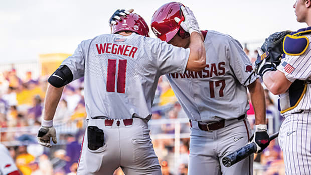 Arkansas Razorback hitter Jared Wegner celebrates his home run with Brady Slavens.